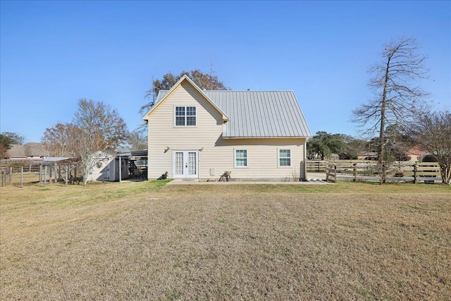 rear view of property featuring a yard and french doors