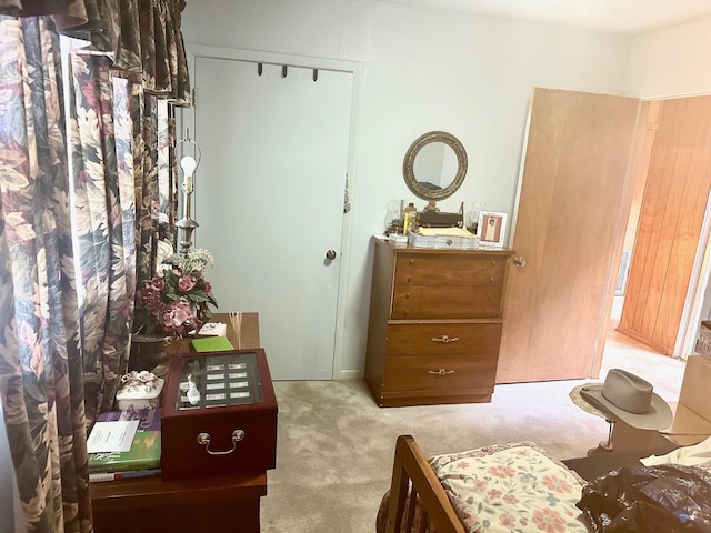 bedroom with light colored carpet and a closet