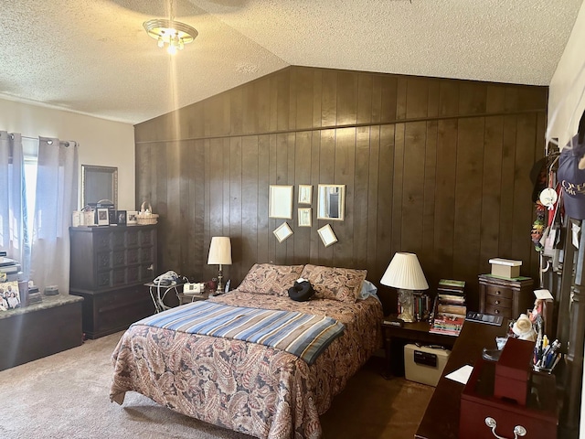 bedroom with dark carpet, a textured ceiling, wooden walls, and vaulted ceiling