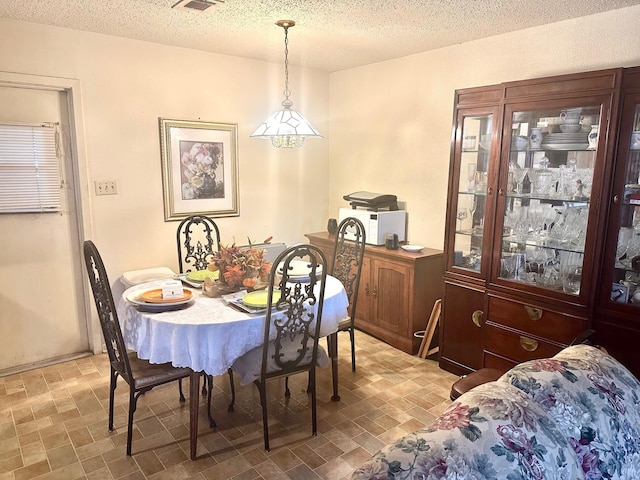 dining room with a textured ceiling