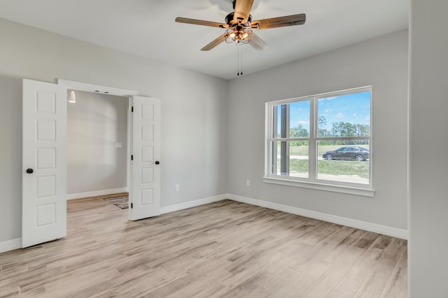 unfurnished bedroom featuring ceiling fan and light hardwood / wood-style floors