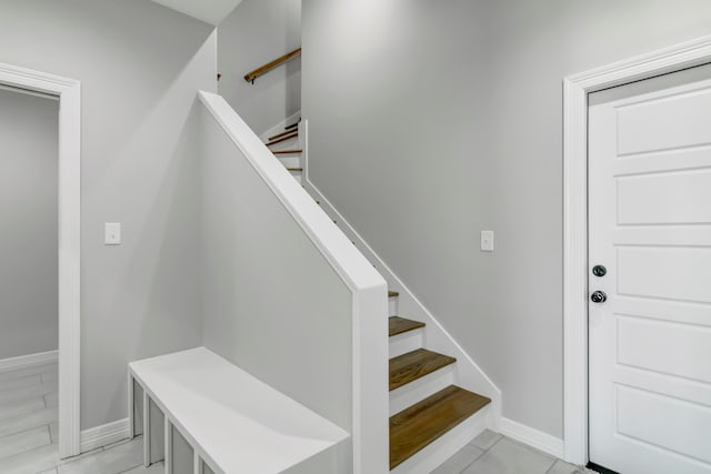 stairs featuring tile patterned floors