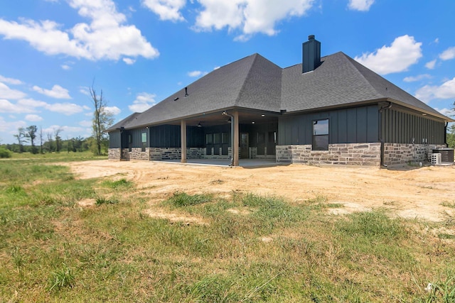 rear view of house with central AC unit