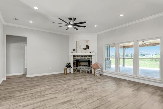 living room featuring ceiling fan, a fireplace, light hardwood / wood-style floors, and ornamental molding