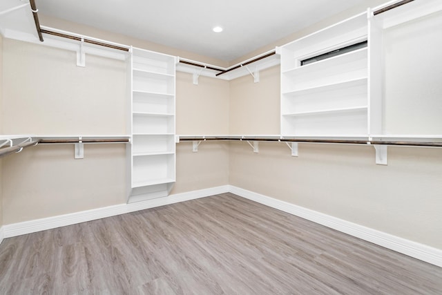 walk in closet with light wood-type flooring