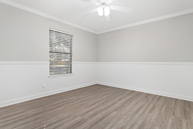 empty room with ceiling fan, hardwood / wood-style floors, and ornamental molding