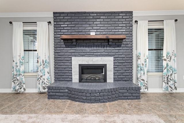 living room featuring a wealth of natural light, ornamental molding, and a brick fireplace