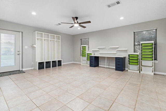 unfurnished living room featuring ceiling fan and light tile patterned floors