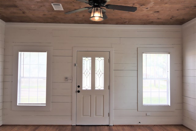 foyer featuring wood walls and wood ceiling