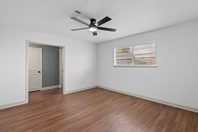 empty room featuring ceiling fan, baseboards, wood finished floors, and visible vents