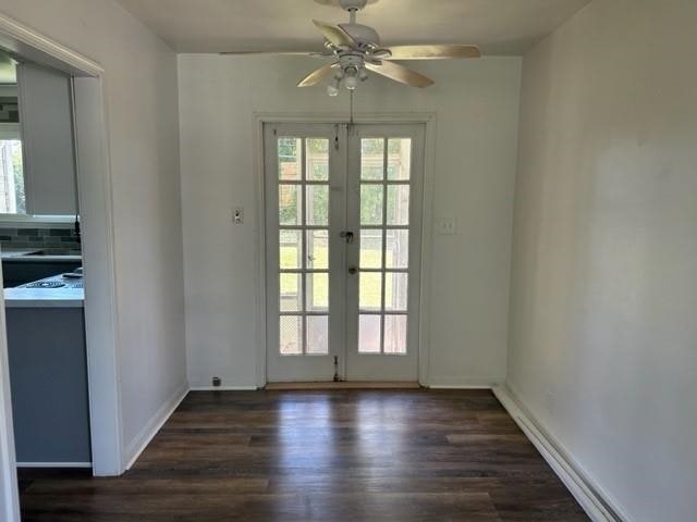 entryway with ceiling fan, french doors, and dark wood-type flooring