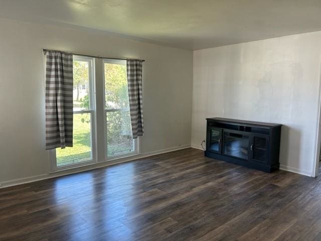 unfurnished living room with dark wood-type flooring