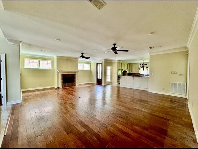 6400 Chasse Gdns, Little Cypress, TX 77632 - unfurnished living room with ornamental molding, hardwood / wood-style floors, baseboards, and ceiling fan