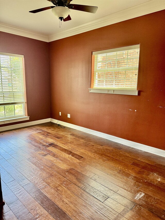 6400 Chasse Gdns, Little Cypress, TX 77632 - spare room with wood-type flooring, crown molding, ceiling fan, and baseboards