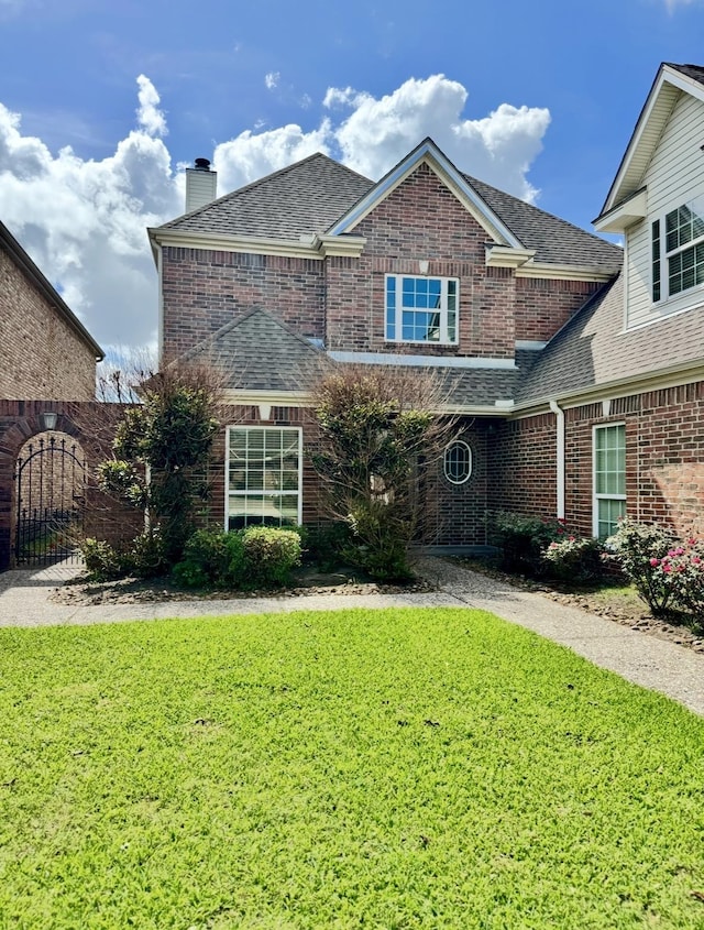 6400 Chasse Gdns, Little Cypress, TX 77632 - view of front of property featuring brick siding, a front yard, a chimney, and a shingled roof