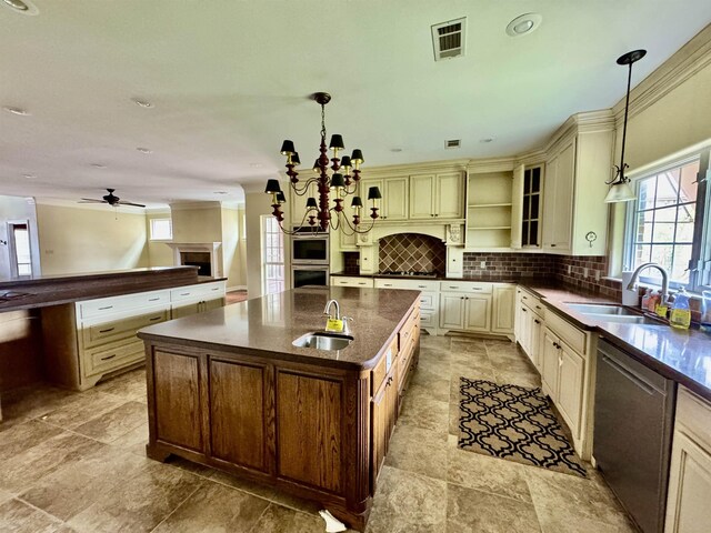 6400 Chasse Gdns, Little Cypress, TX 77632 - kitchen with cream cabinetry, a sink, appliances with stainless steel finishes, and plenty of natural light