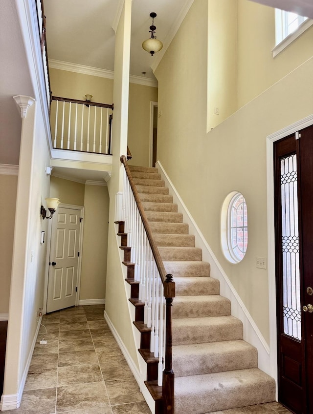 6400 Chasse Gdns, Little Cypress, TX 77632 - foyer entrance with a towering ceiling, stairway, baseboards, and crown molding
