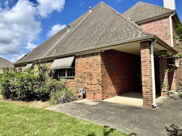 6400 Chasse Gdns, Little Cypress, TX 77632 - back of property with a shingled roof, brick siding, and a chimney
