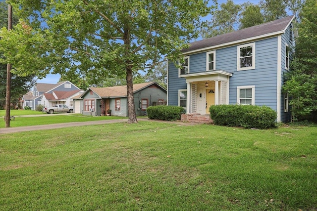2218 Ashley St, Beaumont, TX 77701 - view of front facade featuring a front yard, driveway, and a residential view
