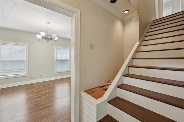 2218 Ashley St, Beaumont, TX 77701 - staircase featuring wood finished floors, a chandelier, and crown molding