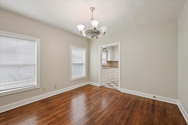 2218 Ashley St, Beaumont, TX 77701 - spare room with a chandelier and wood finished floors