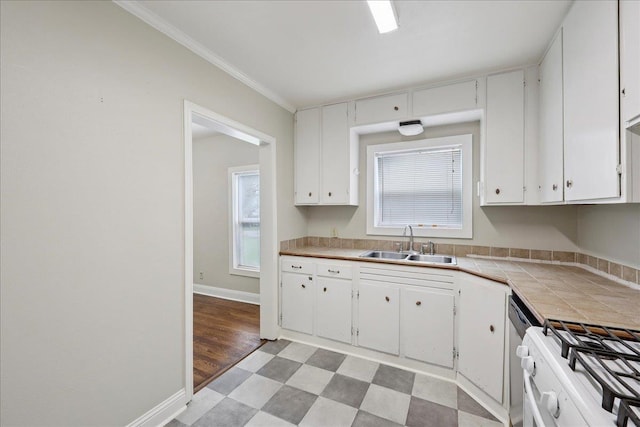 2218 Ashley St, Beaumont, TX 77701 - kitchen featuring tile counters, white cabinetry, ornamental molding, and light floors