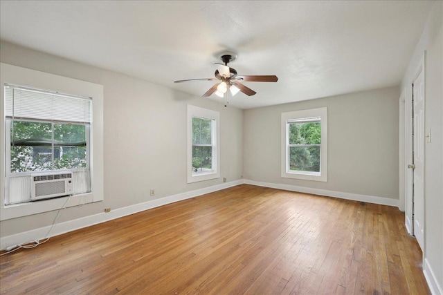 2218 Ashley St, Beaumont, TX 77701 - spare room with healthy amount of natural light, cooling unit, light wood-style flooring, and ceiling fan