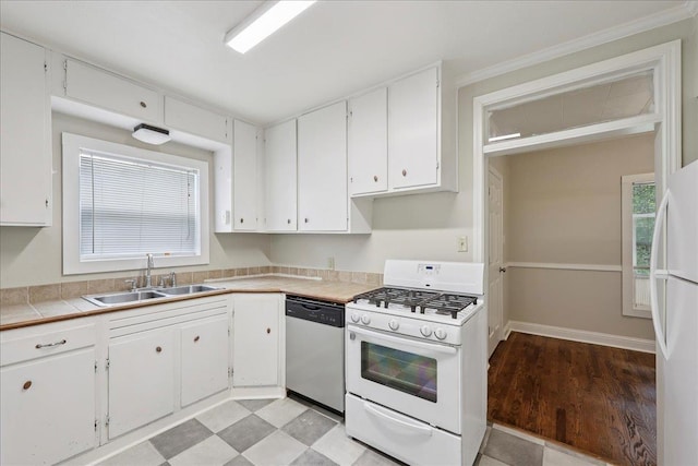 2218 Ashley St, Beaumont, TX 77701 - kitchen with white appliances, white cabinetry, healthy amount of natural light, and light wood-style flooring