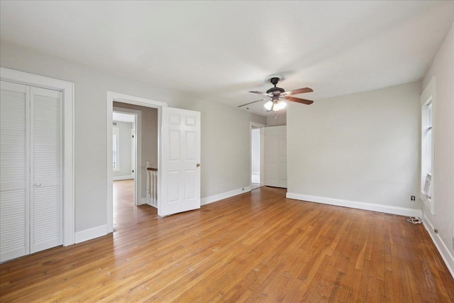 2218 Ashley St, Beaumont, TX 77701 - unfurnished bedroom featuring light wood-style floors, a closet, and a ceiling fan