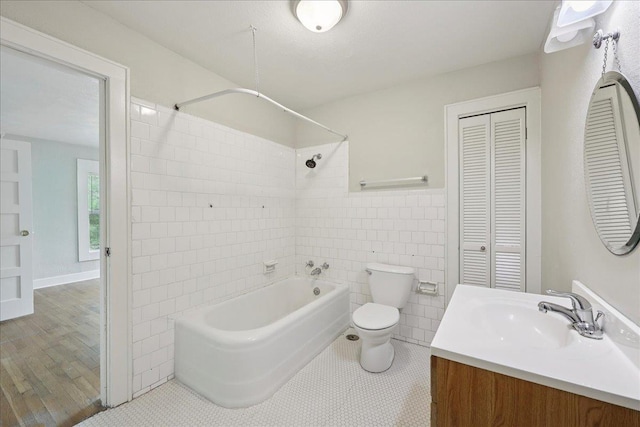 2218 Ashley St, Beaumont, TX 77701 - full bathroom featuring a closet, shower / bathtub combination, vanity, tile walls, and tile patterned floors