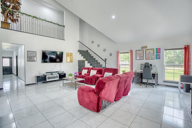 1062 Bassett St, Orange, TX 77632 - living area featuring light marble finish flooring, high vaulted ceiling, an office area, stairway, and baseboards