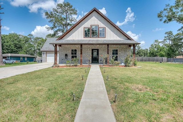 1062 Bassett St, Orange, TX 77632 - view of front of property featuring brick siding, a porch, board and batten siding, and driveway