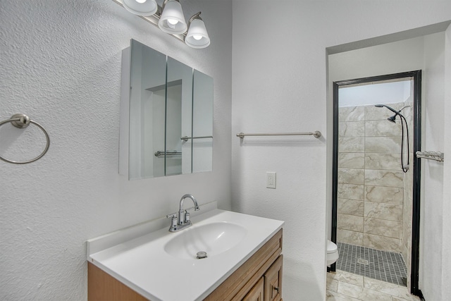1062 Bassett St, Orange, TX 77632 - bathroom featuring a textured wall, toilet, vanity, and a tile shower