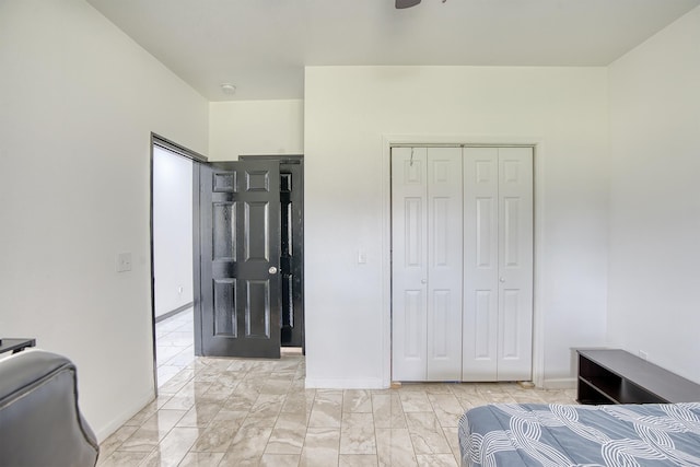 1062 Bassett St, Orange, TX 77632 - bedroom featuring a closet, light marble finish floors, and baseboards