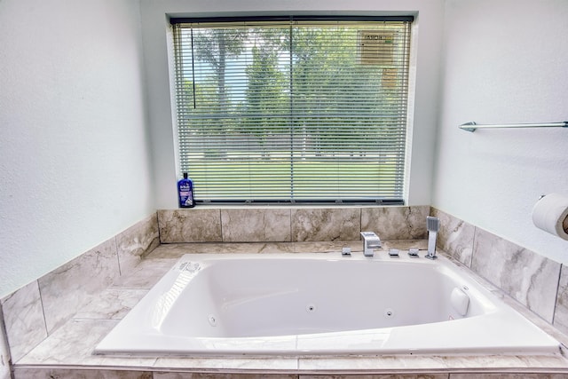 1062 Bassett St, Orange, TX 77632 - bathroom with a jetted tub and a textured wall