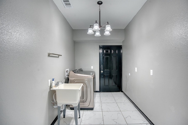 1062 Bassett St, Orange, TX 77632 - clothes washing area with light marble finish flooring, separate washer and dryer, a chandelier, and baseboards
