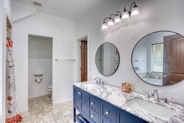 1062 Bassett St, Orange, TX 77632 - bathroom featuring toilet, double vanity, marble finish flooring, and baseboards