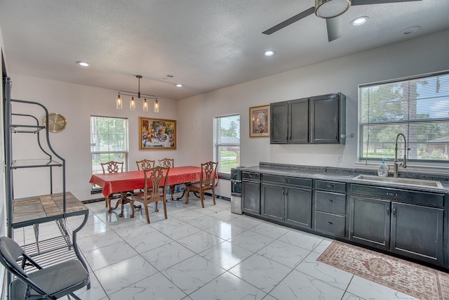 1062 Bassett St, Orange, TX 77632 - kitchen featuring a sink, light marble finish floors, ceiling fan, healthy amount of natural light, and recessed lighting
