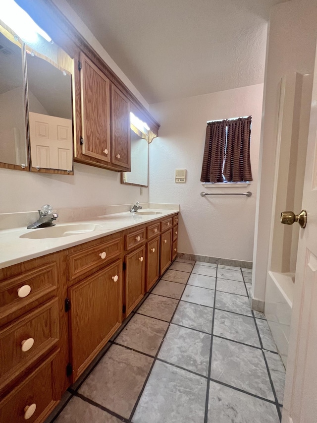 bathroom with a bath and vanity