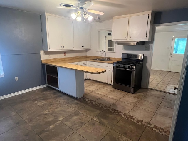 3808 Rachel Ave, Port Arthur, TX 77642 - kitchen with gas stove, under cabinet range hood, white cabinetry, ceiling fan, and a peninsula