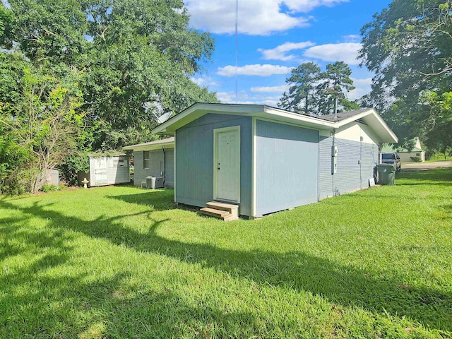 view of outdoor structure featuring a lawn