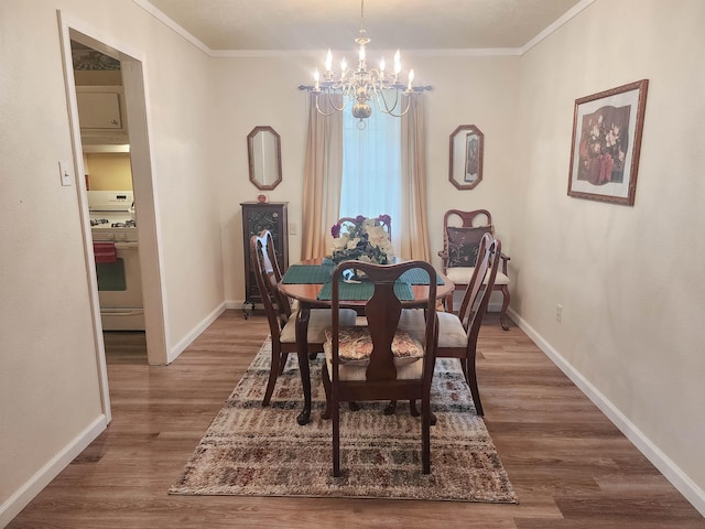 dining space featuring a chandelier, ornamental molding, and hardwood / wood-style flooring