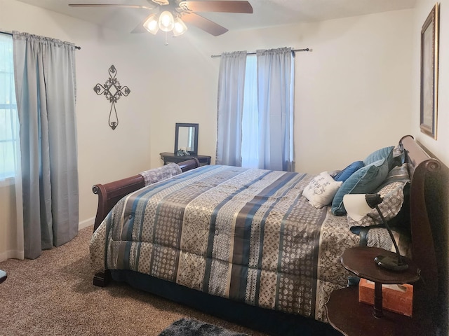 bedroom featuring ceiling fan, multiple windows, and carpet