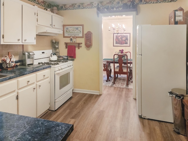 kitchen with white appliances, white cabinetry, light hardwood / wood-style floors, decorative backsplash, and a notable chandelier