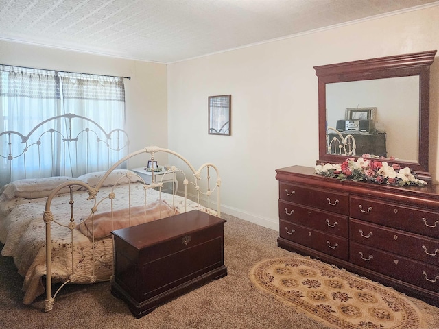 bedroom with carpet floors and a textured ceiling