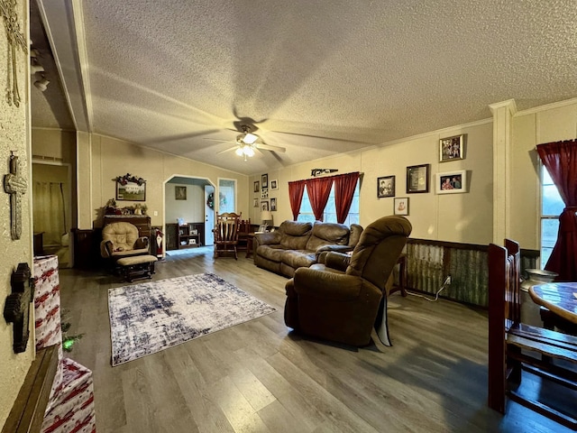 living room with hardwood / wood-style floors, a textured ceiling, ceiling fan, and crown molding