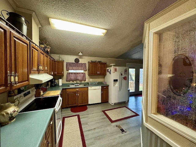 kitchen featuring light wood-type flooring, white appliances, a textured ceiling, sink, and exhaust hood