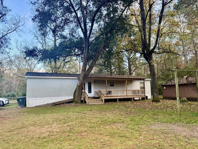 rear view of property with a yard and a deck