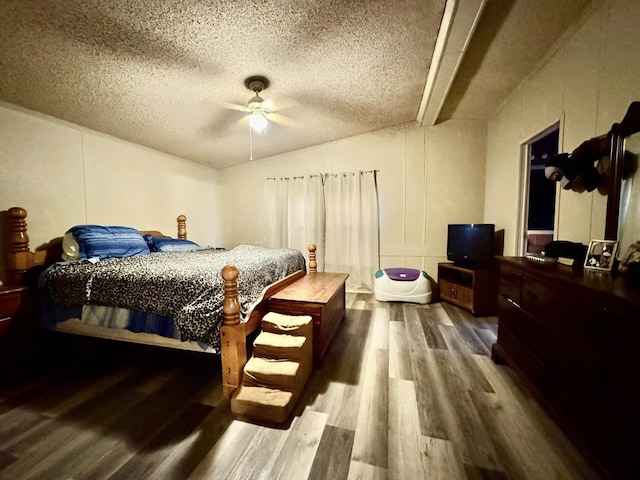 bedroom featuring ceiling fan, hardwood / wood-style floors, and a textured ceiling