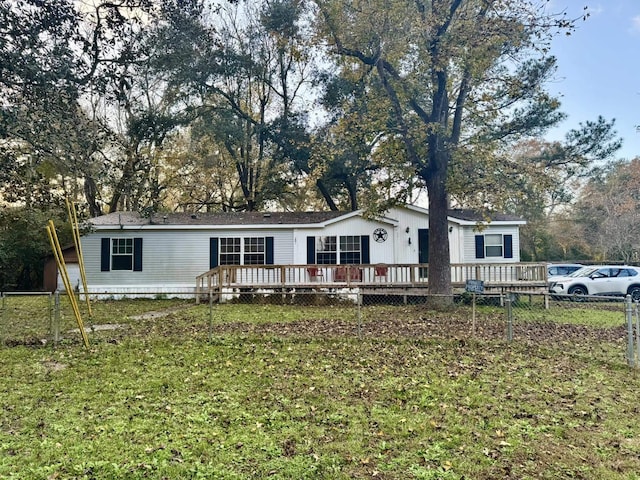 view of front facade with a front lawn and a deck